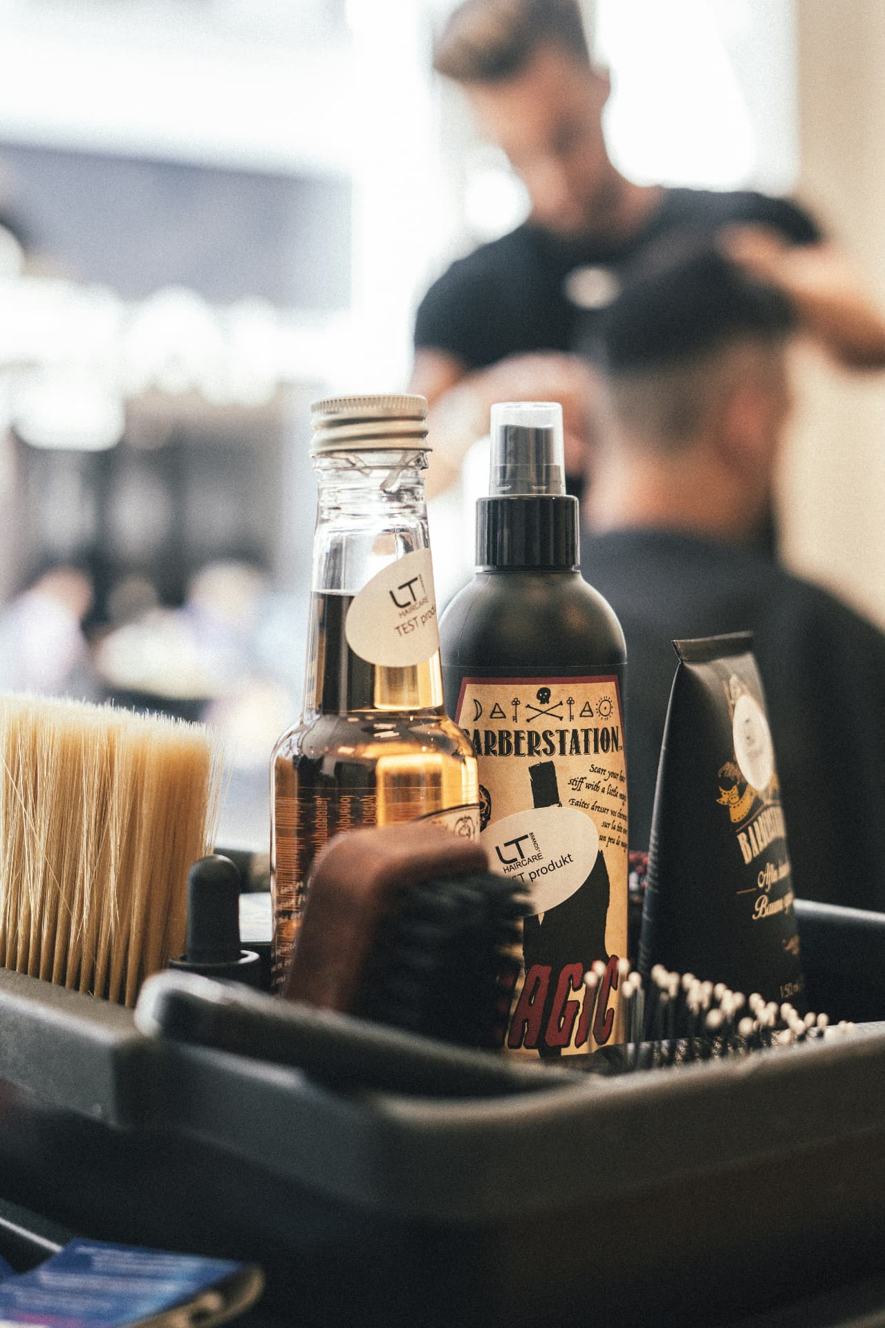 Grooming products and brushes on a barber station