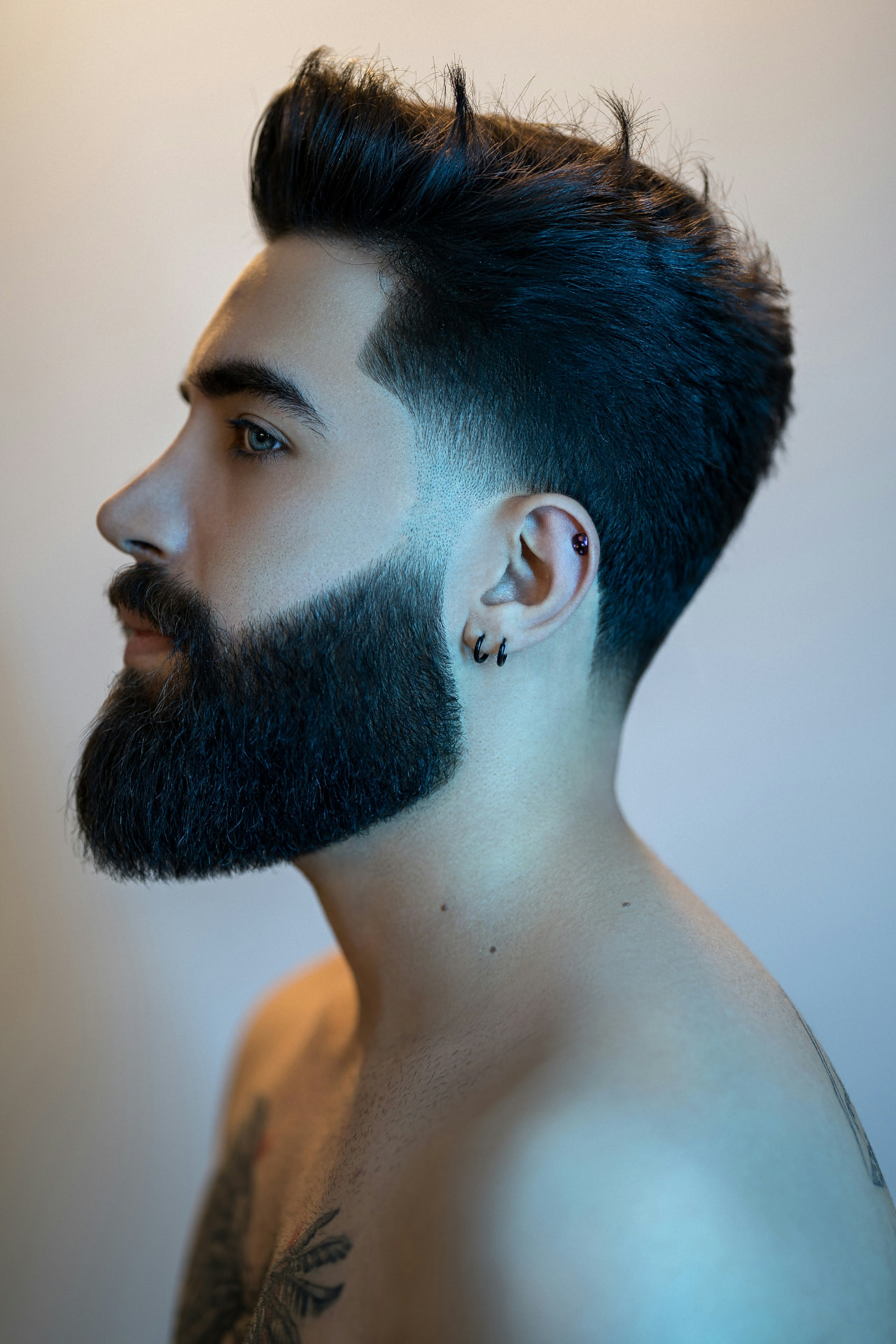 Profile of a client with a tapered fade and sculpted beard